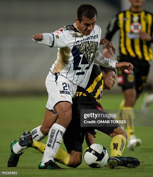 Ismael Iniguez of Pumas vies for the ball with Edder Delgado of Honduran Real Espana during their Concacaf Champions Cup football match in Mexico...
