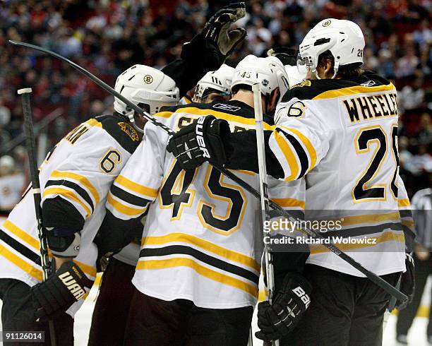 Members of the Boston Bruins celebrate the third period goal by Mark Stuart during the NHL Preseason game against the Montreal Canadiens on September...
