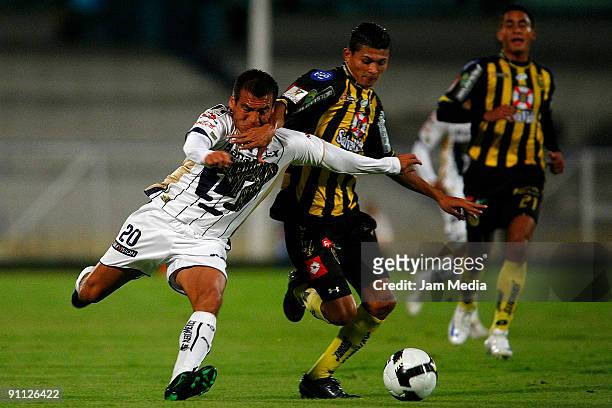 Ismael Iniguez of Pumas and Eder Delgado of Real Espana during their match for the Concacaf Champions League at the Olympic Stadium on September 24,...