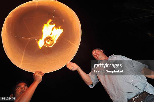 Actor James Belushi lights a Thai Fire Balloon during a dinner ahead of the Bangkok International Film Festival at Catch Beach Club, Surin Beach on...