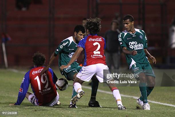 Roberto Nanni and Diego Herder of Paraguay's Cerro Porteno fight for the ball with Fernando and Ernando of Brazil's Goias during their Copa...