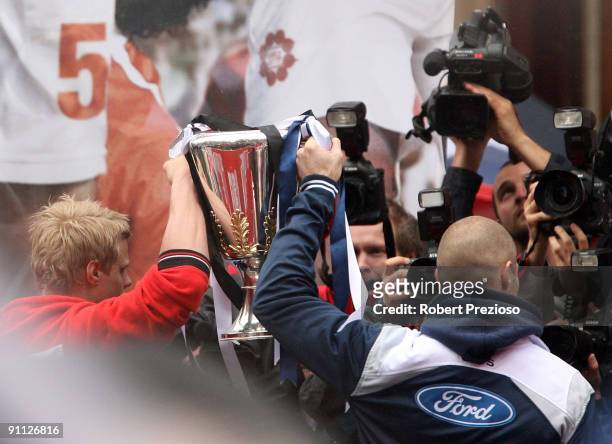 St Kilda Captain Nick Reiwoldt and Geelong Captain Tom Harley hold up the AFL Premiership Cup for the media during the AFL Grand Final parade at...