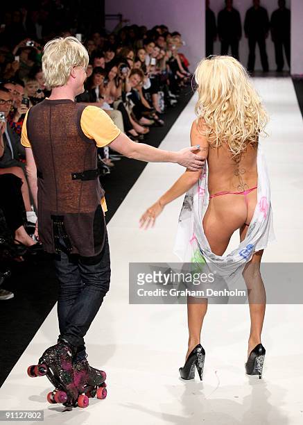 Pamela Anderson and Richie Rich walk the catwalk followoing the A Muse by Richie Rich collection show on day four of Air New Zealand Fashion Week...