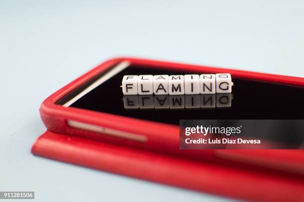 some people are using their mobile phones to do flaming - addiction mobile and laptop stock-fotos und bilder