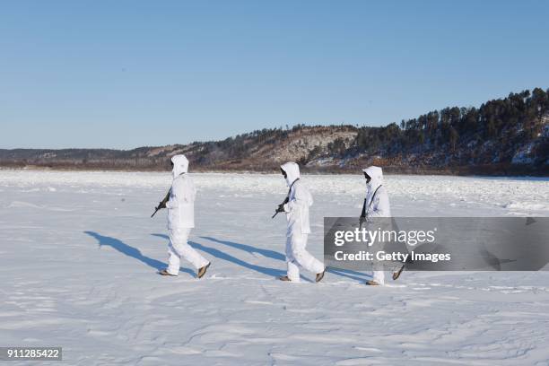 Frontier officers patrol in the snow at Tahe County on January 28, 2018 in Daxing'anling Prefecture, Heilongjiang Province of China.