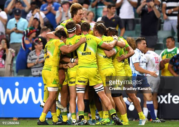 Australia celebrate victory after defeating South Africa in the MenÕs final match during day three of the 2018 Sydney Sevens at Allianz Stadium on...