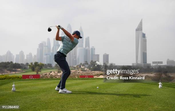 Rory McIlroy of Northern Ireland tees off on the 8th hole with the city as a backdrop during the final round on day four of the Omega Dubai Desert...