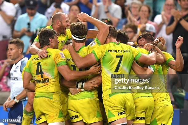 Australia celebrate victory after defeating South Africa in the MenÕs final match during day three of the 2018 Sydney Sevens at Allianz Stadium on...