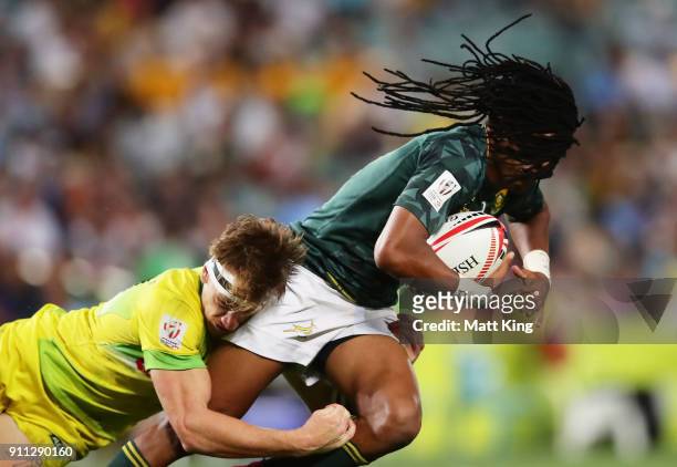 Cecil Afrika of South Africa is tackled by Ben O'Donnell of Australia in the Men's final match during day three of the 2018 Sydney Sevens at Allianz...