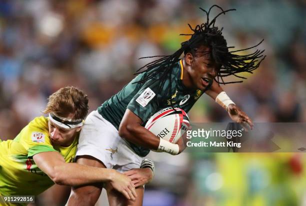 Cecil Afrika of South Africa is tackled by Ben O'Donnell of Australia in the Men's final match during day three of the 2018 Sydney Sevens at Allianz...