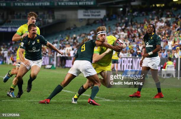 Ben O'Donnell of Australia takes on the defence in the Men's final match against South Africa during day three of the 2018 Sydney Sevens at Allianz...