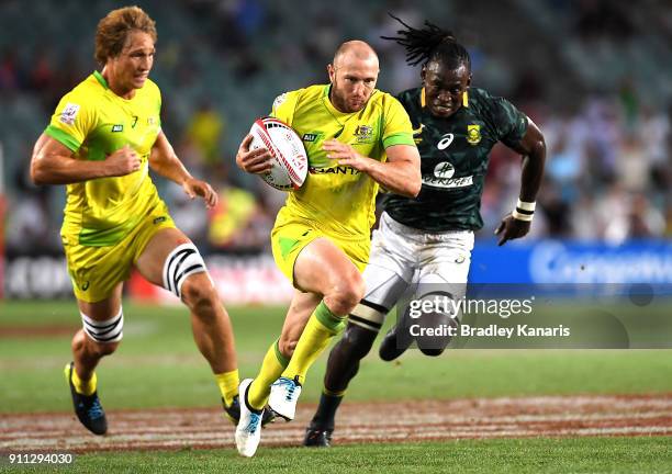 James Stannard of Australia breaks away from the defence in the MenÕs final match against South Africa during day three of the 2018 Sydney Sevens at...