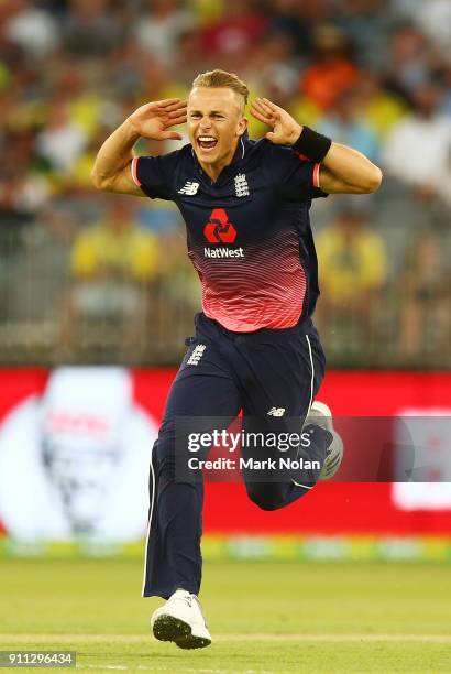Tom Curran of England celebrates a wicket during game five of the One Day International match between Australia and England at Perth Stadium on...