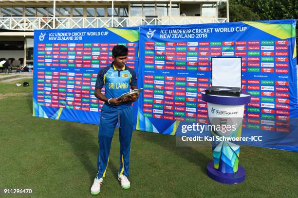 Captain Kamindu Mendis of Sri Lanka holds the trophy after their win in the ICC U19 Cricket World Cup Plate Final match between Sri Lanka and the...