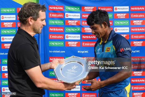 Tournament Director Brendan Bourke presents the trophy to captain Kamindu Mendis of Sri Lanka following the ICC U19 Cricket World Cup Plate Final...