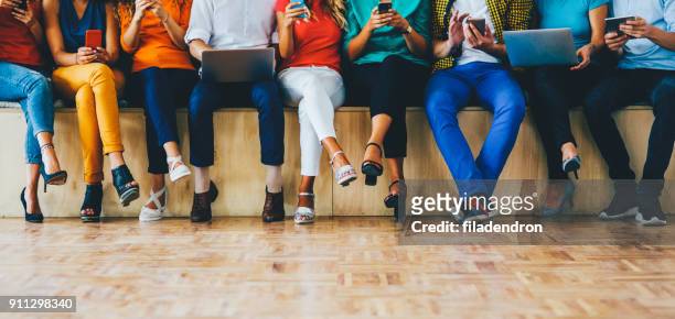 social media concept - legs crossed at knee stock pictures, royalty-free photos & images