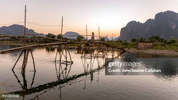 wooden bridge over the nam song river - nam song river stock pictures, royalty-free photos & images