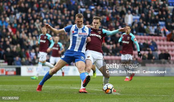 Wigan Athletic's Dan Burn and West Ham United's Toni Martinez during the The Emirates FA Cup Fourth Round match between Wigan Athletic and West Ham...