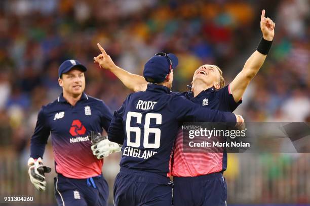 Tom Curran of England celebrates with team mates after getting the final wicket to win game five of the One Day International match between Australia...