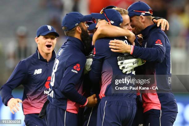 Tom Curran of England celebrates the wicket of Tim Paine of Australia with team mate and winning game five of the One Day International match between...