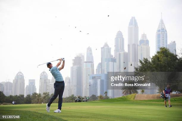 Rory McIlroy of Northern Ireland plays his second shot on the 13th hole during the final round on day four of the Omega Dubai Desert Classic at...