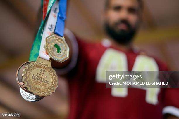 Moataz Radi, 2015 kung fu world champion, shows his medals at a gym in Cairo's western suburb of Sixth of October, on December 3, 2017. Radi, or...