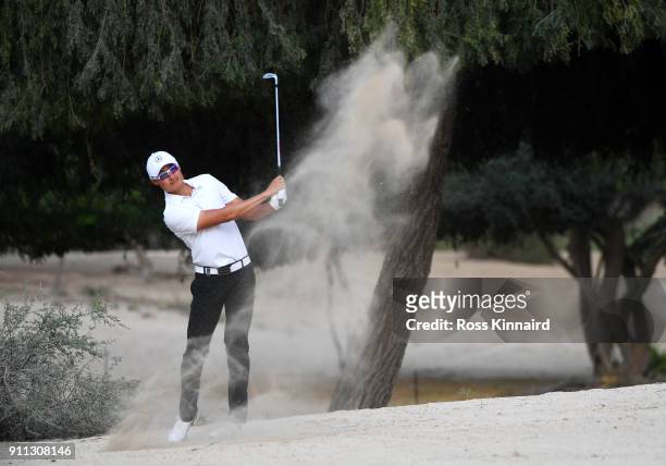 Haotong Li of China plays his second shot on the 14th hole during the final round on day four of the Omega Dubai Desert Classic at Emirates Golf Club...