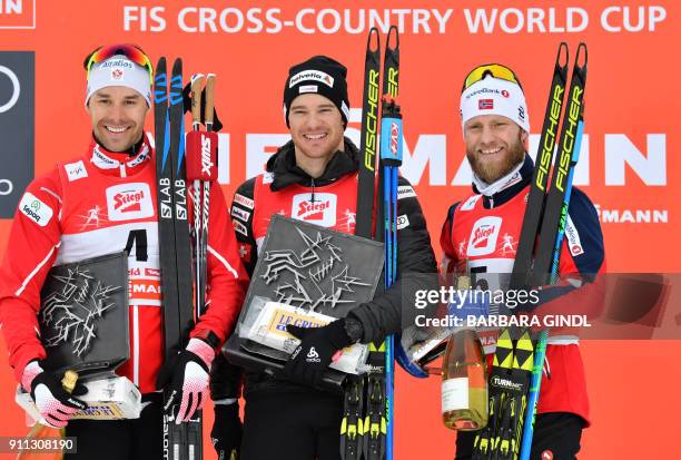 Second placed Alex Harvey of Canada, winner Dario Cologna of Switzerland and third placed Martin Johnsrud Sundby of Norway pose for a picture on the...