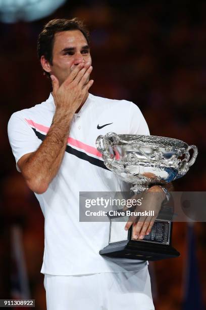 An emotional Roger Federer of Switzerland poses with the Norman Brookes Challenge Cup after winning the 2018 Australian Open Men's Singles Final...