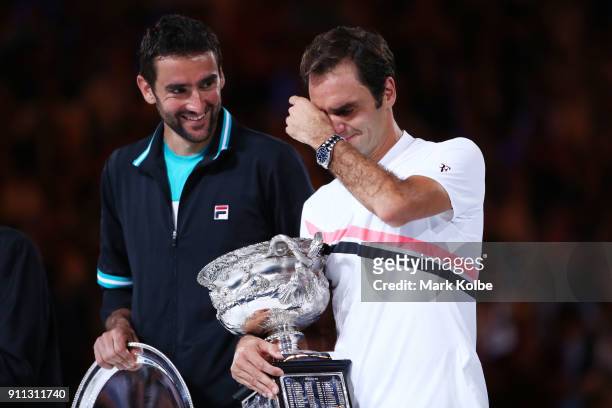 Marin Cilic of Croatia poses with the runners-up trophy and Roger Federer of Switzerland poses with the Norman Brookes Challenge Cup after winning...