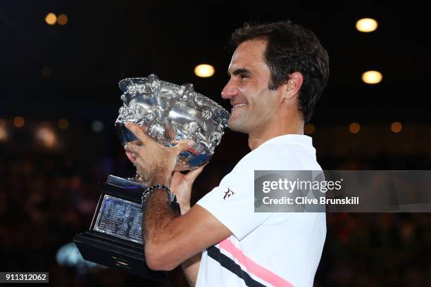 Roger Federer of Switzerland poses with the Norman Brookes Challenge Cup after winning the 2018 Australian Open Men's Singles Final against Marin...