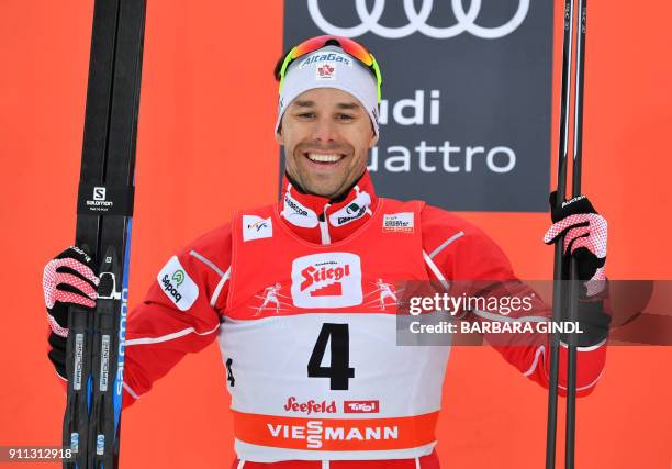 Alex Harvey of Canada celebrates on the podium after finishing second in the Mens FIS Cross Country 15 km Mass Start World Cup on January 28, 2018 in...