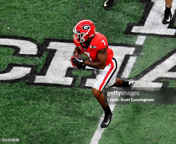 Andre Swift of the Georgia Bulldogs carries the ball against the Alabama Crimson Tide in the CFP National Championship presented by AT&T at...