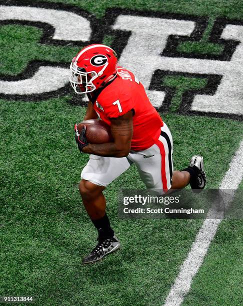 Andre Swift of the Georgia Bulldogs carries the ball against the Alabama Crimson Tide in the CFP National Championship presented by AT&T at...