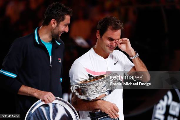 Marin Cilic of Croatia poses with the runners-up trophy and an emotional Roger Federer of Switzerland poses with the Norman Brookes Challenge Cup...