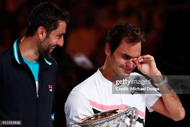 Marin Cilic of Croatia poses with the runners-up trophy and an emotioinal Roger Federer of Switzerland poses with the Norman Brookes Challenge Cup...