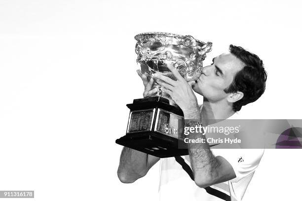 Roger Federer of Switzerland kisses the Norman Brookes Challenge Cup after winning the 2018 Australian Open Men's Singles Final against Marin Cilic...