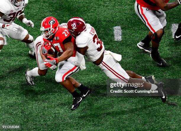 Nick Chubb of the Georgia Bulldogs is tackled by Rashaan Evans of the Alabama Crimson Tide in the CFP National Championship presented by AT&T at...