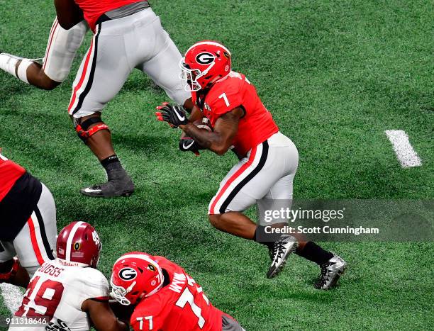 Andre Swift of the Georgia Bulldogs carries the ball against the Alabama Crimson Tide in the CFP National Championship presented by AT&T at...