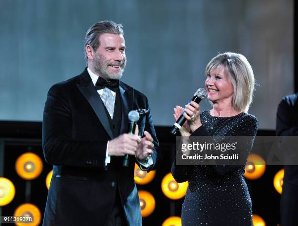 Actor John Travolta and Olivia Newton John speak onstage during the 2018 G'Day USA Black Tie Gala at InterContinental Los Angeles Downtown on January...