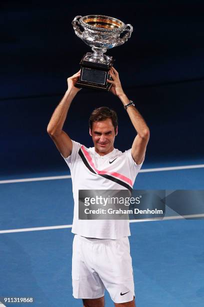 Roger Federer of Switzerland poses with the Norman Brookes Challenge Cup after winning the 2018 Australian Open Men's Singles Final against Marin...