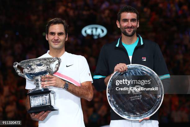 Roger Federer of Switzerland poses with the Norman Brookes Challenge Cup after winning the 2018 Australian Open Men's Singles Final against Marin...