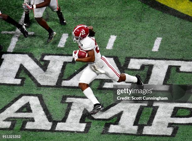 Najee Harris of the Alabama Crimson Tide carries the ball against the Georgia Bulldogs in the CFP National Championship presented by AT&T at...