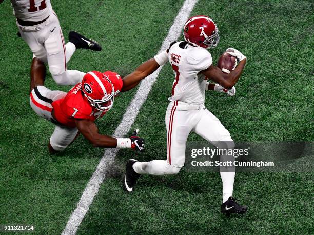 Trevon Diggs of the Alabama Crimson Tide breaks the tackle of Lorenzo Carter of the Georgia Bulldogs in the CFP National Championship presented by...