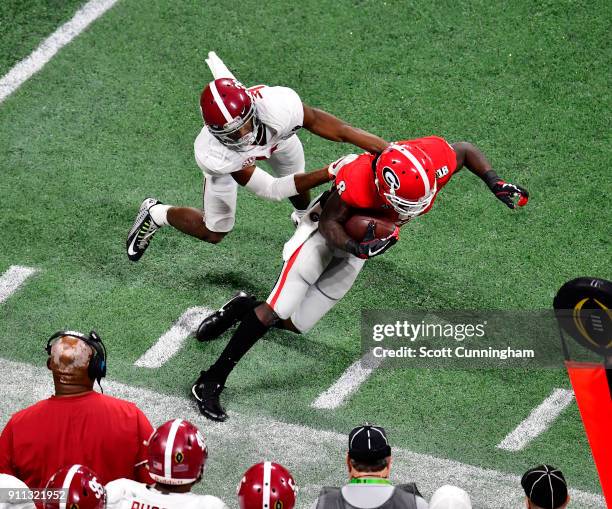 Riley Ridley of the Georgia Bulldogs is forced out of bounds by Levi Wallace of the Alabama Crimson Tide in the CFP National Championship presented...