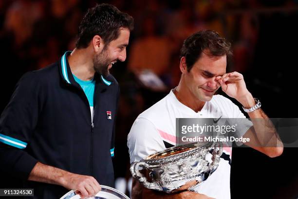 An emotional Roger Federer of Switzerland on stage with the Norman Brookes Challenge Cup after winning the 2018 Australian Open Men's Singles Final...