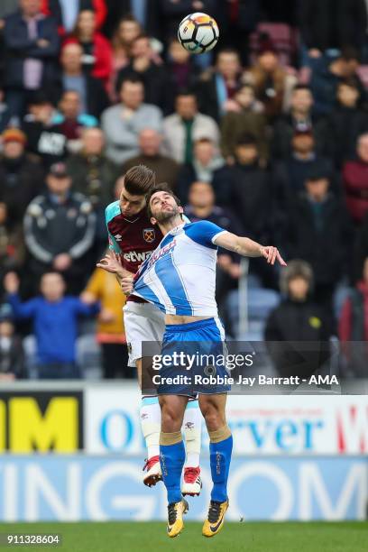 Reece Burke of West Ham United and Will Grigg of Wigan Athletic during the The Emirates FA Cup Fourth Round match between Wigan Athletic and West Ham...