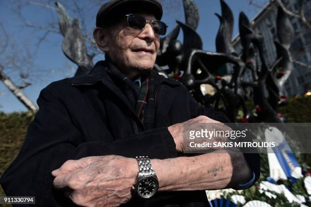 Holocaust survivor Heinz Kounio shows his tattooed serial number on his arm at the Holocaust Memorial in Thessaloniki on January 28 during a ceremony...