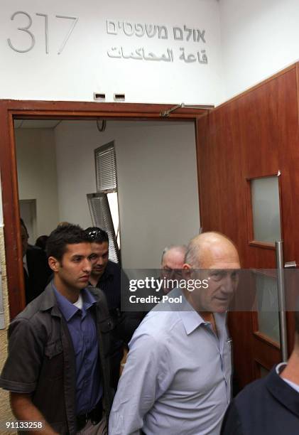 Former Israeli Prime Minister Ehud Olmert arrives in the District Court for the first day of his trial on charges of corruption, on September 25,...