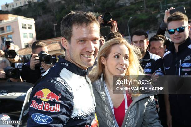 France's Sebastien Ogier smiles next to his wife German television presenter Andrea Kaiser after winning the Monte Carlo Rally in Monte Carlo on...